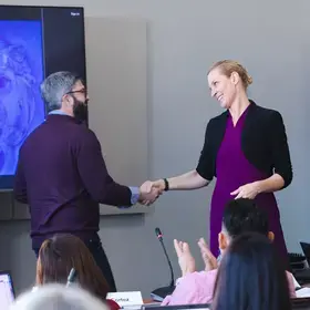 Program Director Alexis Wichowski shaking hands with a student at the Technology Management residency.