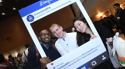 Students posing with in Instagram frame at an SPS event