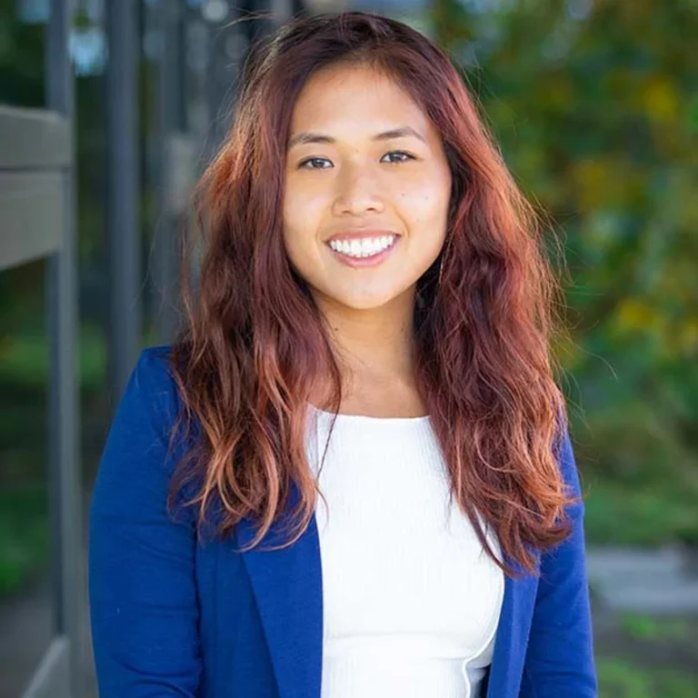 Headshot of Lily Xu in white shirt and blue cardigan.
