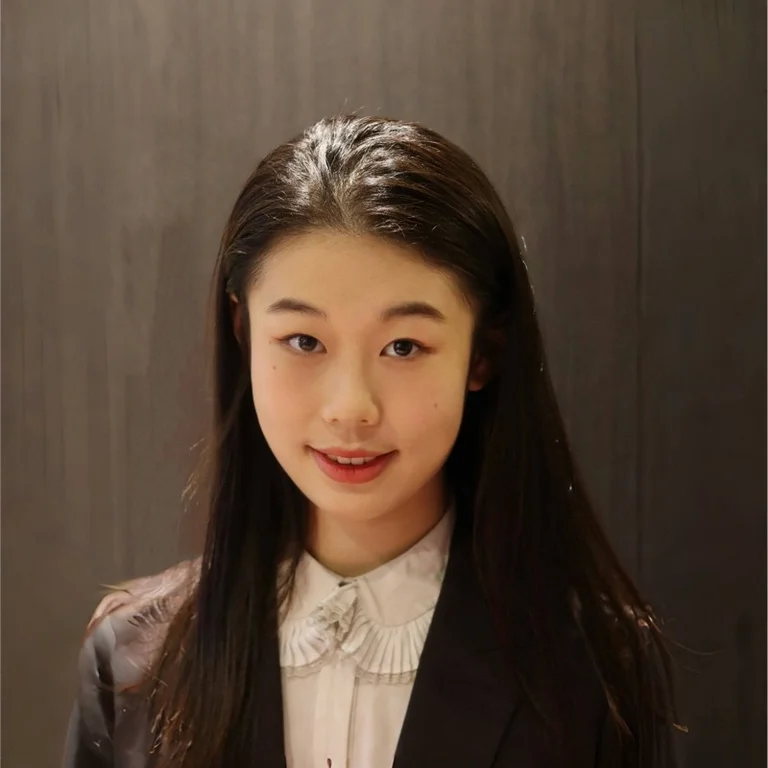 professional headshot of Selina Zhong wearing a white blouse with black suit jacket 