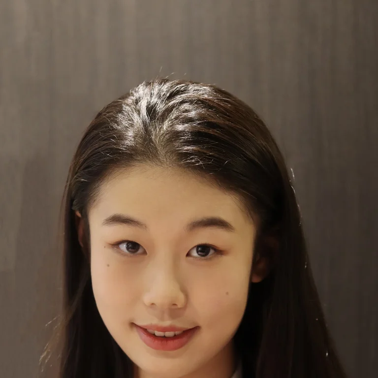 professional headshot of Selina Zhong wearing a white blouse with black suit jacket 