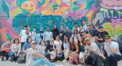 Group photo in front of graffiti mural