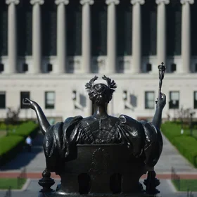 The Alma Mater statue on campus, looking out toward Butler Library.