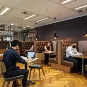 office space with masked employees sitting socially distant
