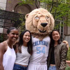Columbia students pose with Roary during an open house in 2017