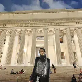 Nonprofit Management M.S. candidate Fatima Jawad Sayed stand on the steps of Low Library at night.