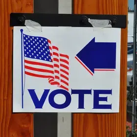 A sign points the way to a local voting booth in the U.S.
