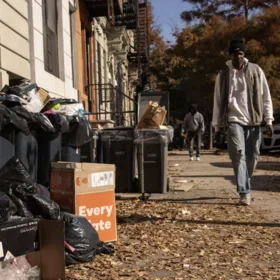 Man walking by overflowing NYC trash