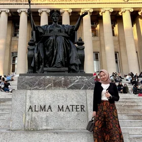 Alma Madina in front of the Alma Mater statue on campus
