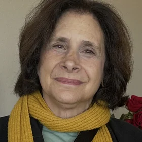 photo of Susan Cafetz Li wearing yellow scarf and green shirt