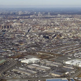 Bronx, the north end of Manhattan, the George Washington Bridge, and New Jersey, from foreground to background, with Hunts Point Market on the right
