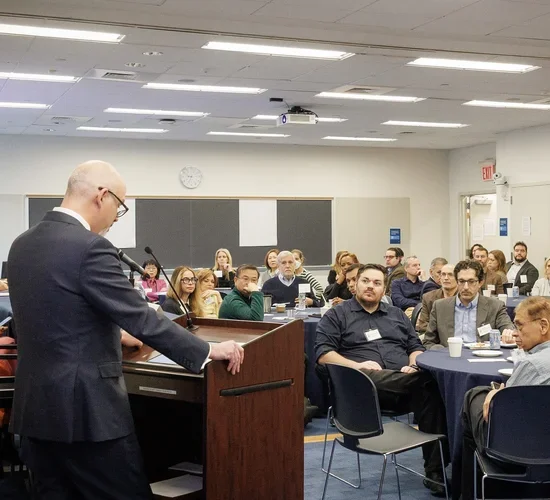 Dean Troy Eggers speaks to attendees of the SPS AI Faculty Summit