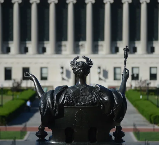 The Alma Mater statue on campus, looking out toward Butler Library.