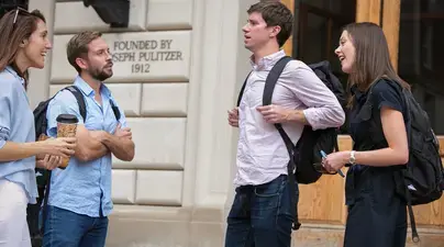 Four students conversing outside Pulitzer Hall.