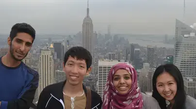 Four students with a view of the Empire State Building