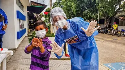 Child and medical work wear face masks. SOURCE: Americares, Ana Maria Ariza, photographer