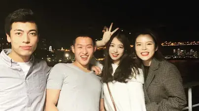 An image shows Actuarial Science alumnus Eric Huang (second from left) outside in New York City with three of his classmates.