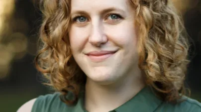 Smiling redhead in sleeveless green blouse