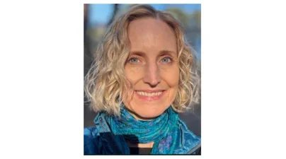 smiling caucasian woman with curly blonde bob and turquoise scarf