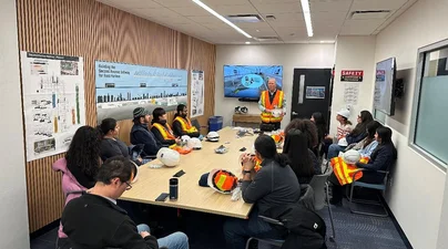 Inside the MTA offices, students receive PPE and a site safety briefing before the tour.