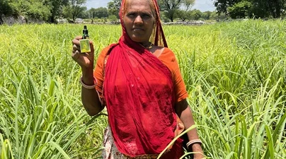 Kanku Bai holds lemongrass essential oil produced from crops grown on her farm in Rajasthan, India.