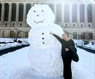 Alma Madina with a snowman on Columbia's campus